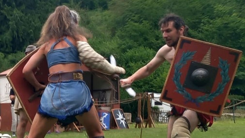 Two gladiators fighting in a combat demonstration at Chedworth Roman Villa